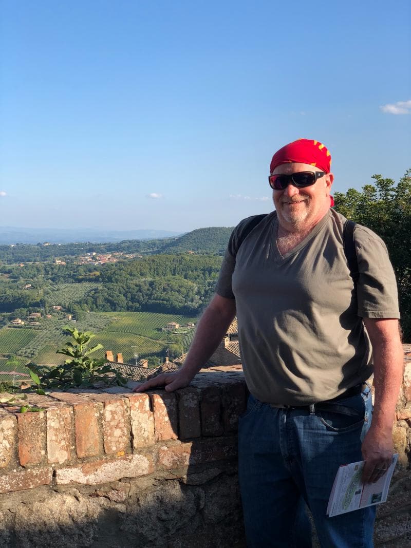 Traveler wearing a bandana in Tuscany for sun protection during long sightseeing days