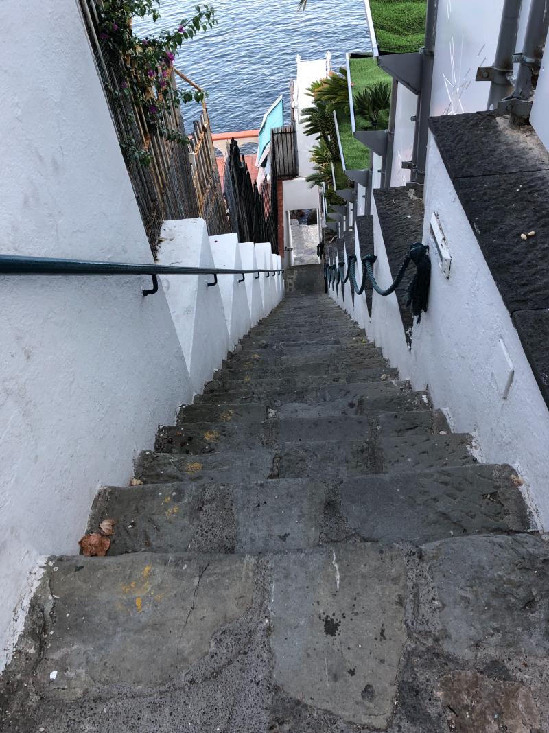 Steep stairs on the Amalfi Coast showing why light luggage and day bags matter in Europe