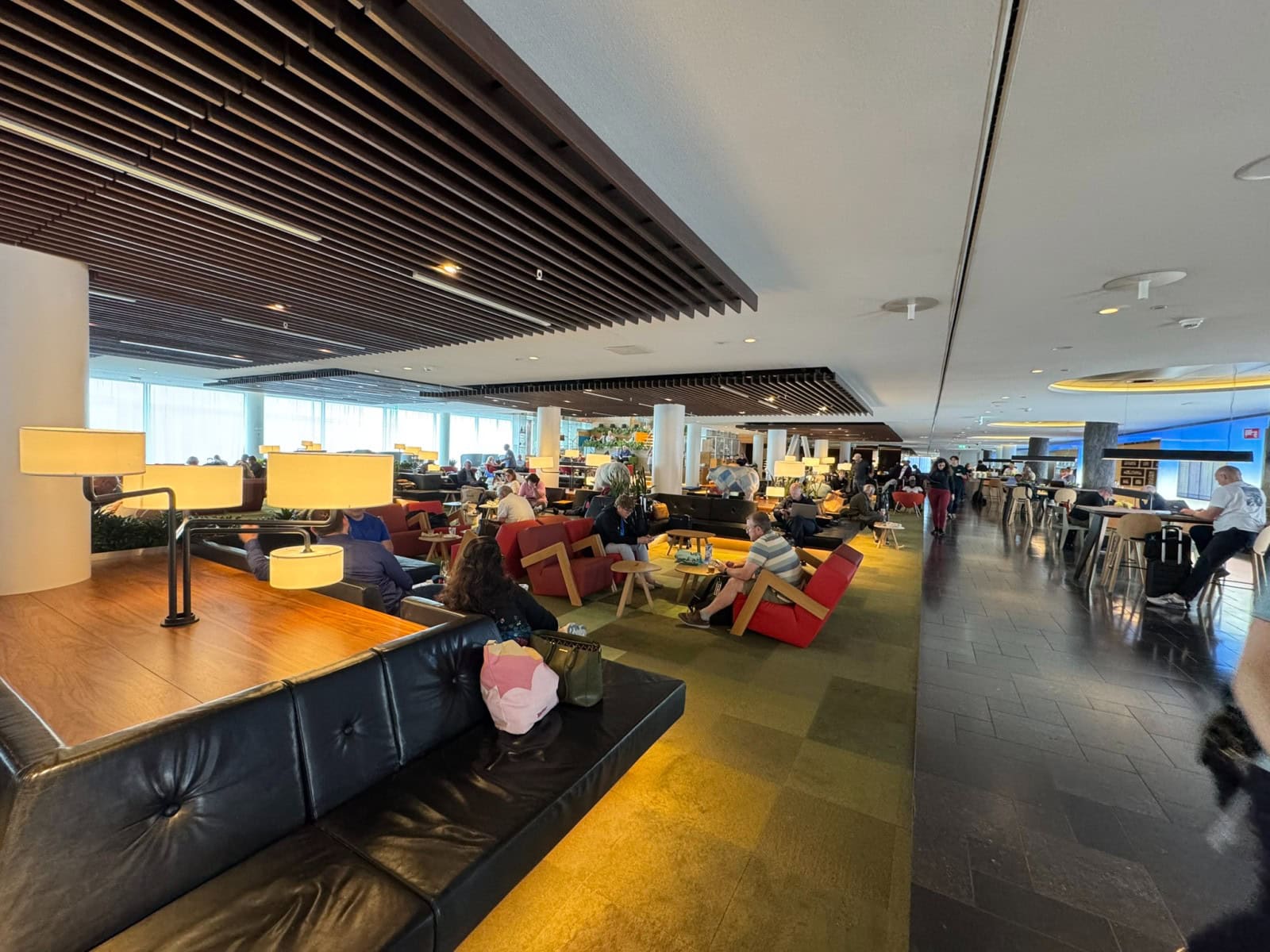 Airport lounge seating area showing a quieter premium travel experience before an international flight