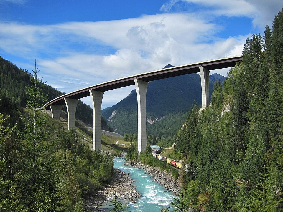 Park Bridge at Kicking Horse Pass near Golden British Columbia with river, train, forest, and mountain scenery