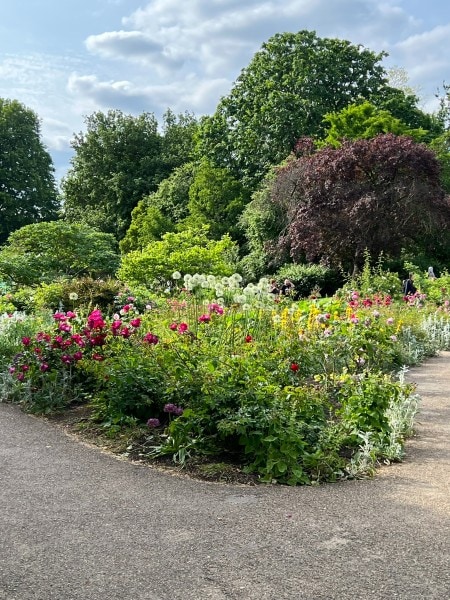 Colorful flower garden and walking path in Hyde Park, one of London's most famous green spaces