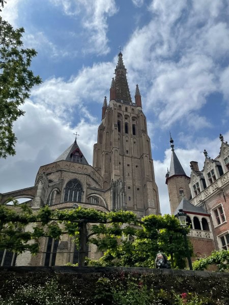 Church of Our Lady in Bruges, Belgium viewed from a historic courtyard garden