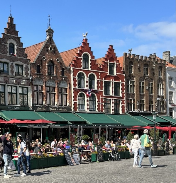 Historic buildings and outdoor cafés in Market Square, Bruges, Belgium