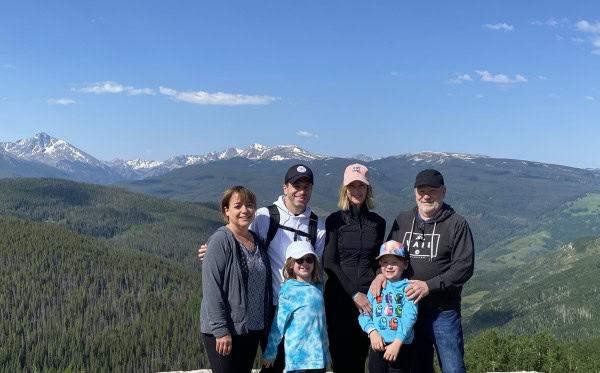 Randy, Leslie, their son, daughter-in-law, grandson, and granddaughter enjoying a mountain overlook in Colorado.