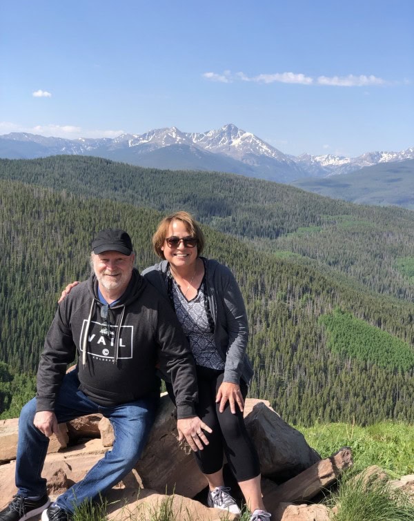 Randy and Leslie overlooking the Colorado Rockies from a scenic mountain viewpoint.
