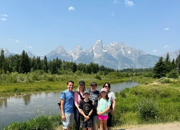 Randy, Leslie, their son, daughter-in-law, grandson, and granddaughter with the Grand Teton Mountains in Grand Teton National Park, Wyoming.