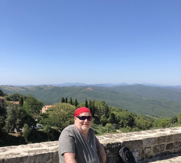 Traveler overlooking the rolling hills and countryside of southern Tuscany near Montalcino and Montepulciano
