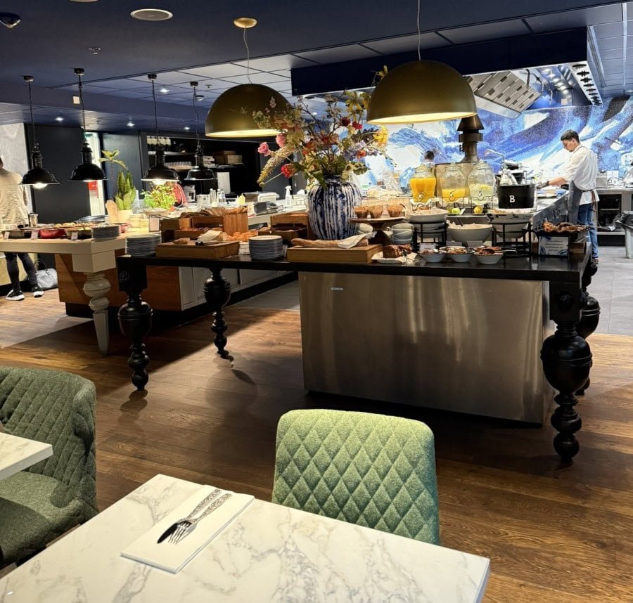 Hotel breakfast buffet featuring fresh fruit, hot selections, pastries, and made-to-order options included with the stay.