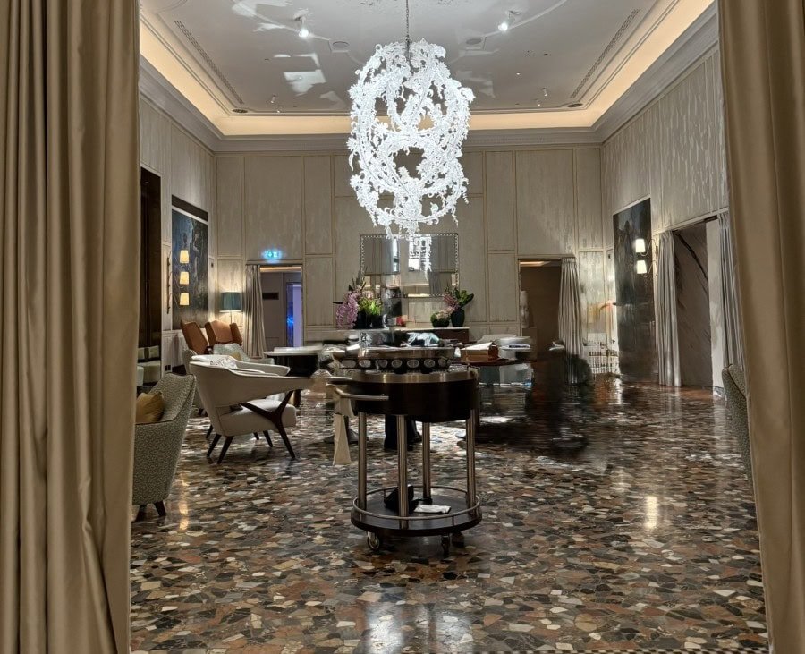 Elegant hotel lobby in Venice featuring comfortable seating, high ceilings, and a welcoming atmosphere that enhances the overall guest experience.
