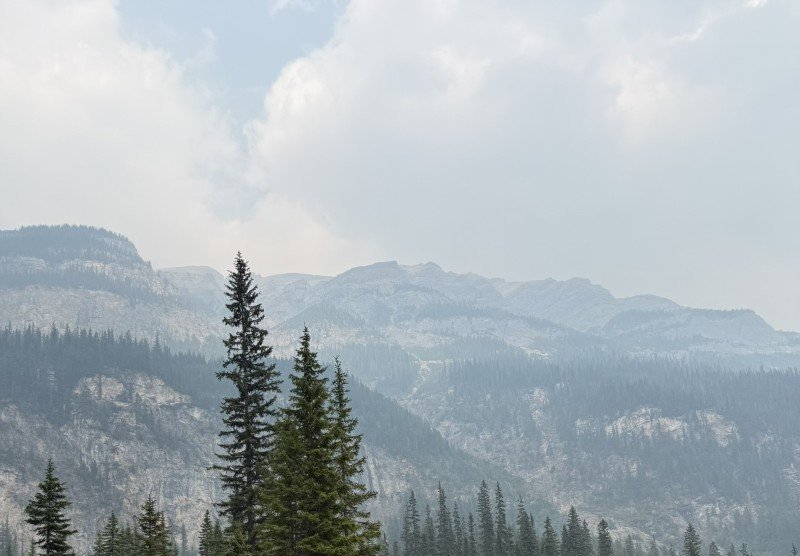 Canadian Rockies mountain views through wildfire haze on our drive from Calgary toward Golden