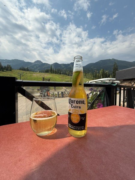 Beer on the Peaks Grill patio with mountain views at Kicking Horse Mountain Resort in Golden, British Columbia