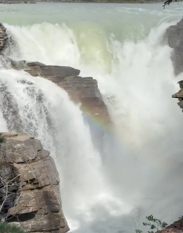 Rainbow forming in the mist at Athabasca Falls in Jasper National Park
