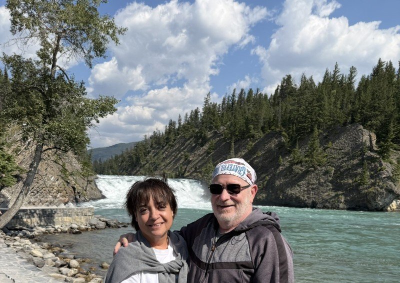Couple at Bow Falls overlooking the Bow River in Banff