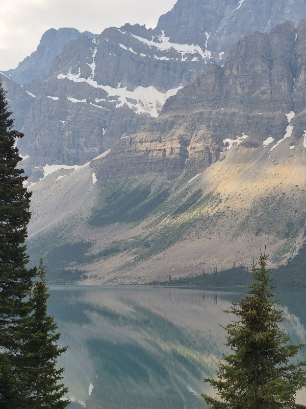 Mountain cliffs reflected in Bow Lake