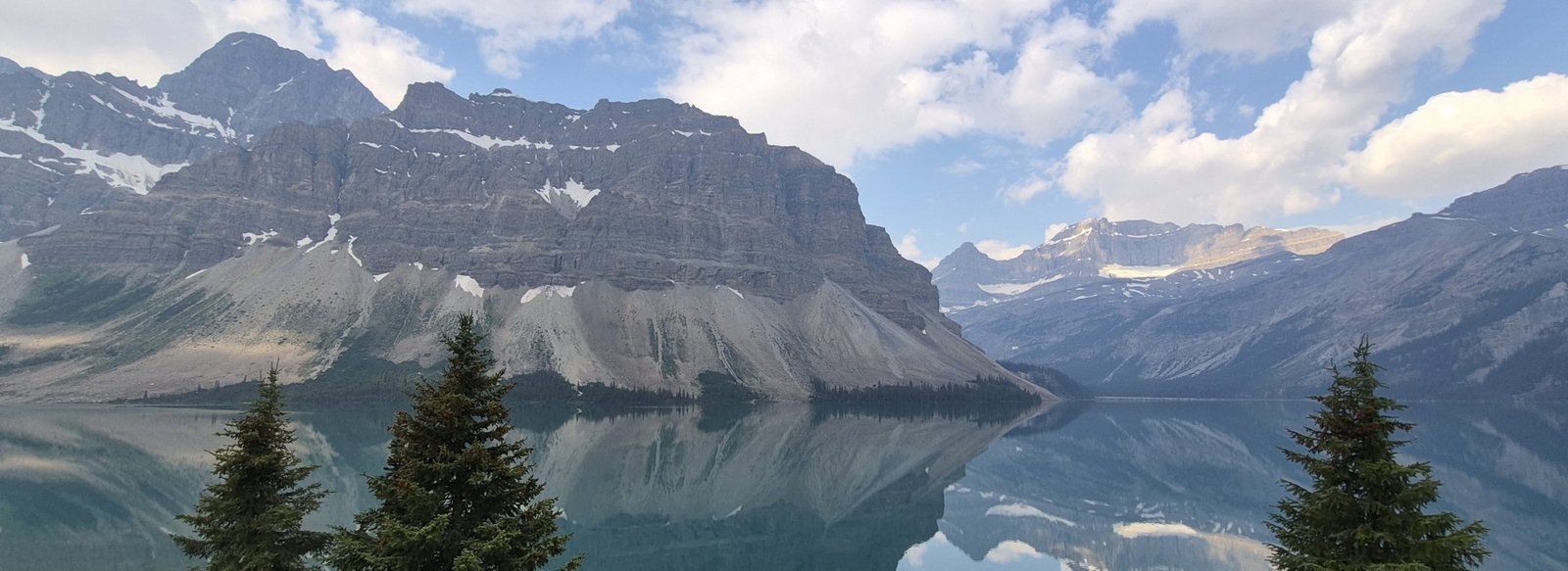 Panoramic mountain reflections on Bow Lake along the Icefields Parkway