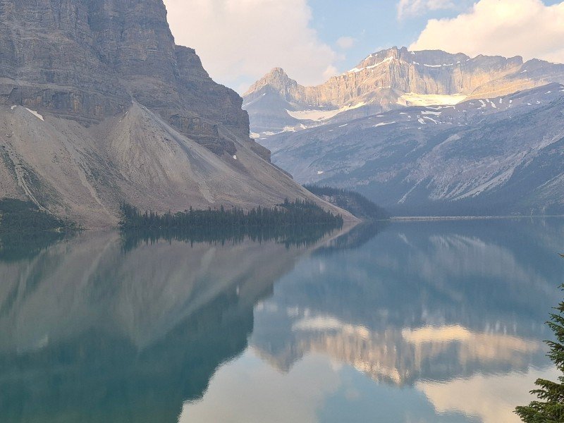 Symmetrical mountain reflection on Bow Lake