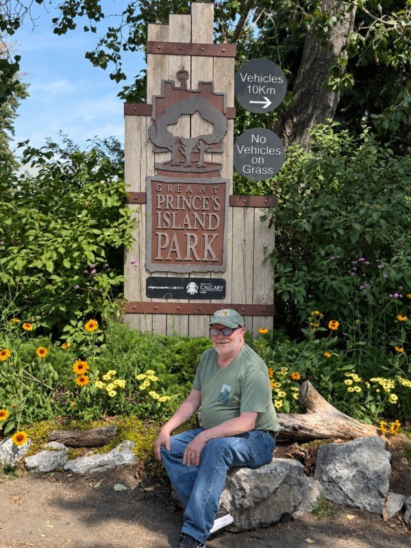 Traveler at the Prince's Island Park sign in Calgary, Alberta