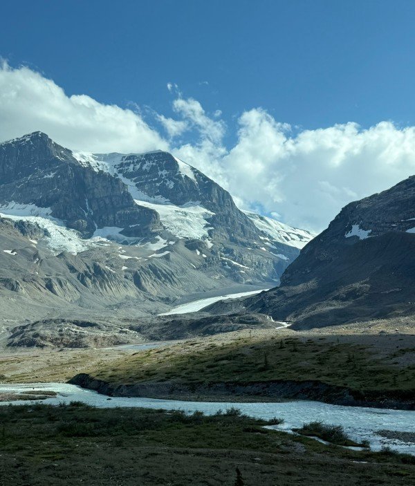 Glacier and alpine lake beneath mountains along the Icefields Parkway