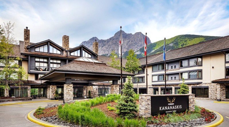 Exterior of Pomeroy Kananaskis Mountain Lodge with the Canadian Rockies behind it