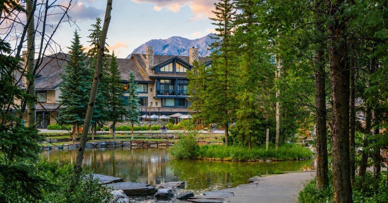 Pomeroy Kananaskis Mountain Lodge surrounded by trees and mountain scenery