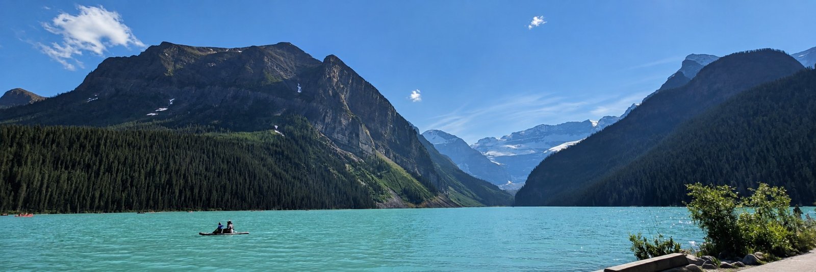 Panoramic view of turquoise Lake Louise and surrounding Canadian Rockies