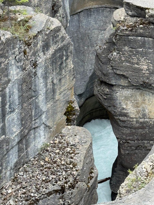 Narrow rock gorge with turquoise water at Mistaya Canyon