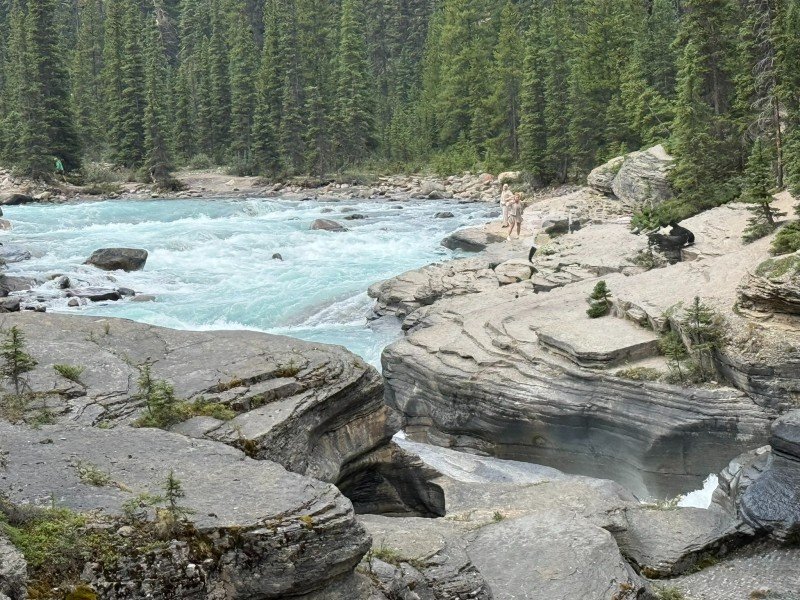 Turquoise water rushing through the rock formations at Mistaya Canyon