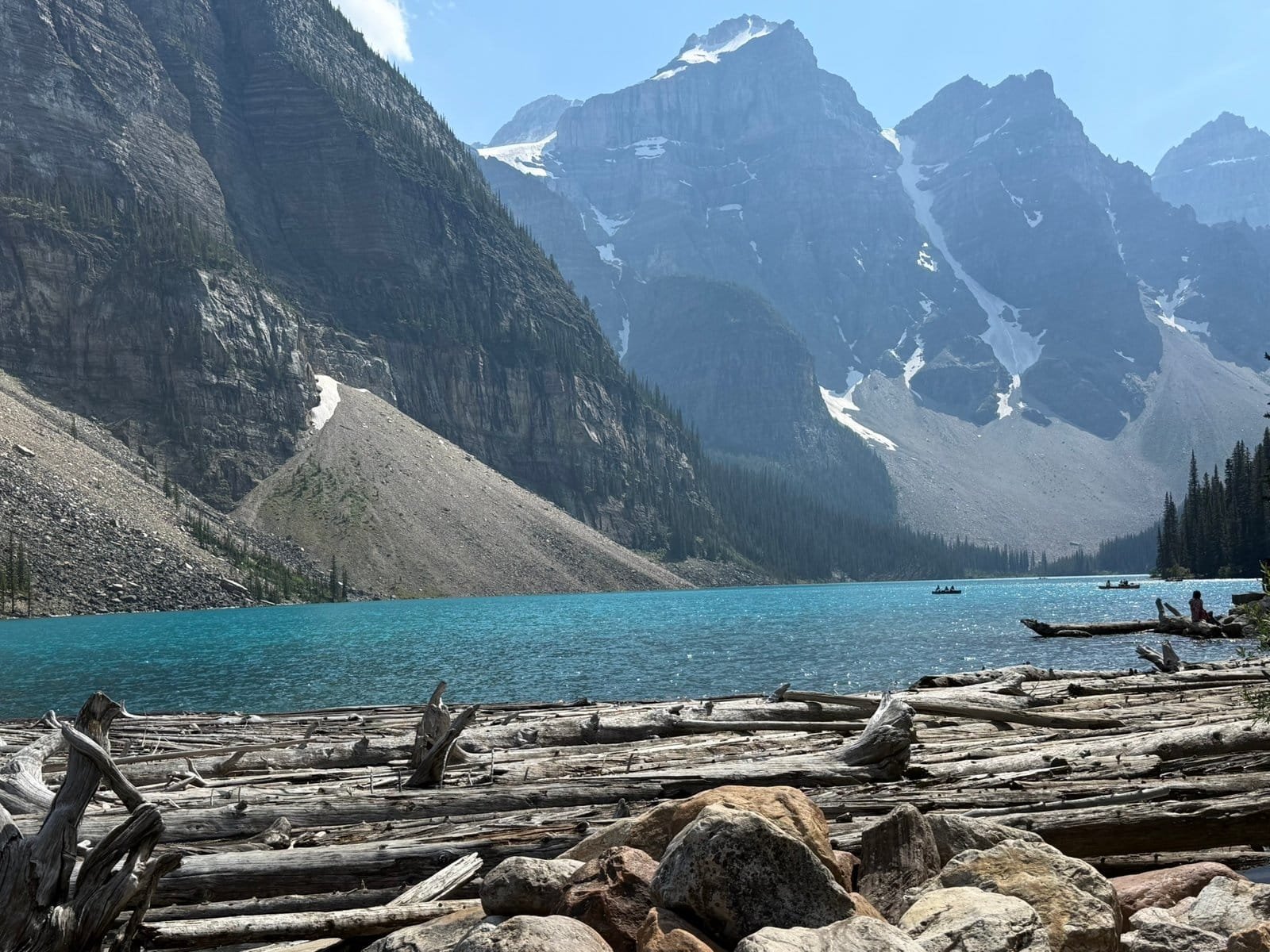 Moraine Lake shoreline with turquoise water and mountain peaks in Banff