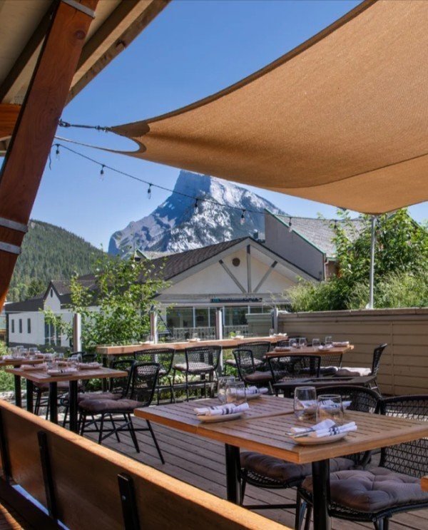 Rooftop patio at The Bison Restaurant in Banff with mountain views